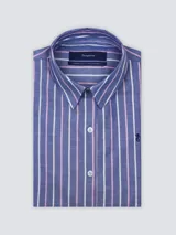 Camisa blanca de algodón, de corte suelto, manga larga y cuello clásico, con cierre frontal de botones y bordado sutil en el pecho.