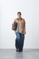 Sobrecamisa de gamuza color marrón con bordados decorativos estilo western en la zona de los hombros y cierre frontal con botones metálicos.