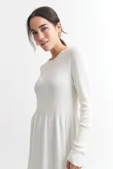 Vestido tejido azul marino de corte a la rodilla, con cuello redondo y mangas largas.