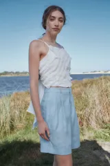 Bermuda negra de lino de talle alto con pliegues debajo de la cintura, piernas anchas con tablas y botamanga.