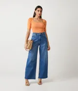 Blusa de punto acanalado color naranja, con escote cuadrado y mangas cortas con volados en los puños.