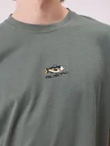 Remera negra de corte holgado con pequeño logo bordado en el pecho que incluye un diseño de pez y la marca Rusty.