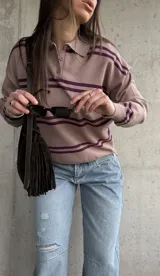 Sweater de punto color lavanda con diseño rayado en tonos morados, cuello polo con botones y mangas largas.