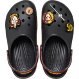 Zuecos Crocs negros con suela a rayas horizontales rojas y amarillas, inspiradas en la bufanda de Gryffindor. Incluyen charms de Jibbitz de Harry Potter y el nombre de la casa Gryffindor en la tira del talón.