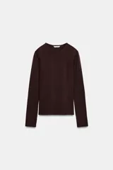 Camiseta de manga larga y cuello redondo, con corte ajustado al cuerpo.