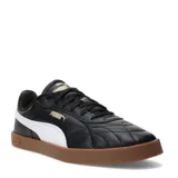 Championes urbanos Puma Club II Indoor, color negro con detalles en blanco y suela de goma color caramelo. Presentan un diseño acolchado en la puntera y el logo de la marca en dorado.