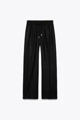 Pantalón azul marino de lino, de tiro alto con cintura elástica ajustable con cordones, bolsillos delanteros y pernera recta.