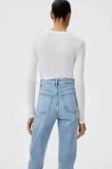 Jean tobillero de cinco bolsillos en denim de tiro alto, con pierna recta y ajuste ceñido en el bajo.