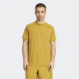 Remera deportiva Adidas de manga corta y cuello redondo, color mostaza/amarillo ocre, con un pequeño logo Adidas en relieve en el pecho. Presenta costuras reforzadas en los hombros.