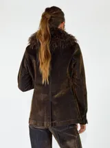 Chaqueta de denim azul oscuro con cuello de piel sintética desmontable, cierre frontal con botones metálicos y bolsillos delanteros con solapa.