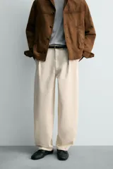 Pantalón relaxed fit color rosado, confeccionado en tejido de algodón con efecto lavado. Presenta pliegues frontales, bolsillos delanteros y bolsillos traseros de vivo. Cierre frontal con cremallera y botón.