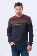 Remera de manga larga con cuello redondo, diseño a rayas horizontales en tonos bordó, azul marino y mostaza. Confeccionada en algodón y poliéster.