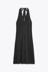 Vestido midi negro de tejido fluido, con cuello halter que se anuda en la nuca y escote pronunciado en pico.