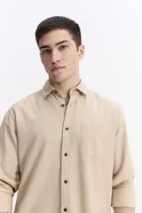 Camisa de manga larga color azul marino con textura, cuenta con cuello clásico, cierre frontal con botones y un bolsillo en el pecho.