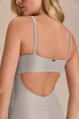 Jumpsuit corto de diseño ajustado con escote cuadrado y breteles finos. Confeccionado en tejido técnico con acabado ligeramente brillante y textura acanalada, ofrece compresión media y alta elasticidad.