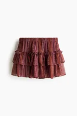 Short pollera mini de gasa con estampado paisley en tonos bordó y naranja, con cintura elástica y diseño escalonado con múltiples volados.