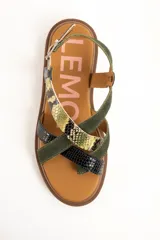 Sandalias planas de cuero con suela track marrón y tiras cruzadas en el empeine con diseño texturizado en tonos verde, negro y animal print de serpiente, además de una tira ajustable al tobillo con hebilla metálica.