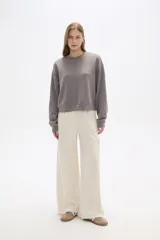 Pantalon de corte amplio y tiro alto, confeccionado en poliester, con bolsillos laterales tipo cargo.