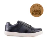 Zapato casual de cuero color azul marino con perforaciones decorativas en los laterales y cordones grises.