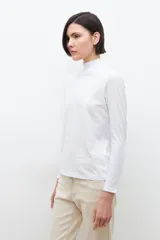 Remera de manga larga color blanco, con cuello alto con volados.