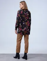 Blusa negra con estampado floral en tonos borgoña, rosa y blanco. Tiene cuello a la base con escote en V y botones.