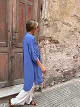 Sobrecamisa larga color celeste, de corte oversize, con mangas largas abotonadas y cierre frontal con botones.