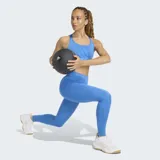 Calza deportiva Adidas de tiro alto, color azul, con diseño ajustado y tecnología AEROREADY para absorción de humedad. Presenta costuras mínimas y logo de la marca en el muslo.