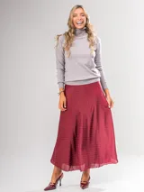 Falda midi color beige con lunares blancos, de corte evasé y cintura elastizada.