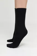 Pack de dos pares de medias blancas de caña alta, con base de toalla y logo de la marca en negro.