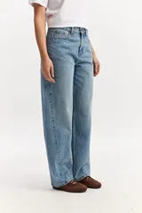 Jean baggy de tiro medio confeccionado en algodón, con diseño de piernas amplias, estilo slouchy y efecto gastado.