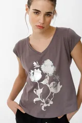 Remera gris con cuello en V, mangas cortas y estampado de flores plateadas metalizadas.