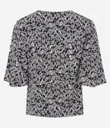 Blusa de viscosa con estampado de follaje en blanco y negro, escote en V y mangas cortas.