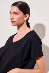 Remera de algodón color mostaza, de manga corta y escote en V con detalle metalizado.