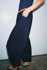 Pantalón de tiro medio confeccionado en mezcla de lyocell, con diseño de pierna ancha y tejido en espiga. Cuenta con cintura elástica ajustable con cordones y bolsillos laterales.