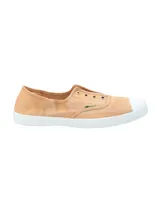 Zapatilla tipo sneaker de diseño ligero y fresco, confeccionada en algodón orgánico teñido a mano en tono arcilla. Presenta puntera reforzada de goma blanca, suela de caucho natural y ojales metálicos decorativos.