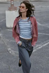 Jeans de tiro alto con corte balloon y pernera holgada. Presenta diseño de cinco bolsillos, cierre frontal con cremallera y botón, y detalle de costuras marcadas en el delantero y la espalda.