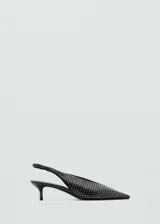 Zapato destalonado negro de tacón fino bajo, con punta fina y toda la superficie decorada con tachas plateadas pequeñas.