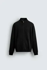 Chaqueta de punto compacto en hilatura de algodón, con cuello subido, manga larga y cierre frontal con cremallera. Presenta bolsillos laterales en costura y acabados en rib.