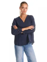 Blusa de algodón azul marino con bordado floral al tono. Presenta escote en V con terminación festoneada y mangas largas ligeramente abullonadas con puños abotonados. Su diseño es de silueta fluida y relajada.