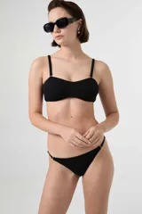 Top de bikini bandeau negro con textura acanalada, tirantes ajustables y removibles.