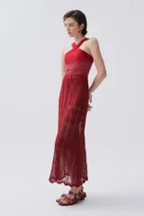 Top de tiras cruzadas color rojo. Su cuerpo tejido se amolda a la silueta y las tiras cruzadas permiten tener los hombros al descubierto, sujetando bien el busto.