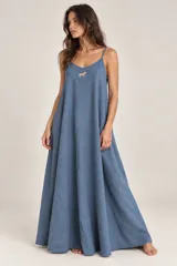Vestido largo mostaza con tirantes finos, escote en V y silueta amplia, con detalle de pequeño bordado en forma de caballo en el pecho.