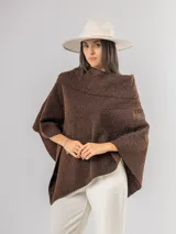 Poncho de tejido texturizado en color marrón chocolate, con cuello amplio y diseño asimétrico.
