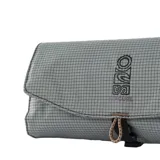Necessaire Rip Curl modelo Sseries Dopp Kit de color gris, con diseño geométrico cuadriculado y cierre de solapa con cordón elástico.