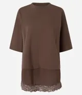 Remera marrón de algodón con cuello redondo, mangas cortas amplias y diseño de superposición con una capa inferior que presenta borde de encaje.