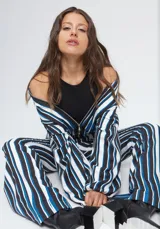 Pantalón de corte semi oxford con estampado de rayas verticales en azul, blanco y negro. Presenta aberturas en la parte inferior y está confeccionado en crepe.