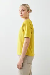 Remera de manga corta con diseño raglán y detalle de vainillas en las costuras de los hombros. Presenta un corte clásico y cuello redondo.