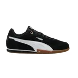 Championes Puma modelo Bella Donna, de diseño urbano y deportivo en color negro con la franja lateral característica en blanco. Presentan una suela de goma color caramelo con excelente tracción y detalles en dorado en los ojales de los cordones.