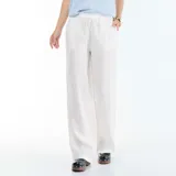 Pantalón de lino blanco de corte ancho, con cintura elástica ajustable mediante cordón y bolsillos laterales.