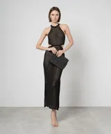 Vestido largo negro calado de malla con lunares brillantes, cuello halter, cortes en los laterales, aberturas laterales y forro.